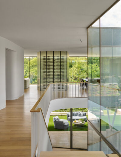 Second floor of modern home interior leading to stairs.