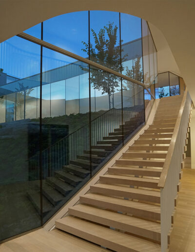 Modern staircase, with floor to ceiling glass windows.