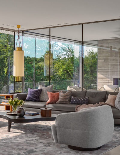 Modern home interior design with floor to ceiling glass windows.